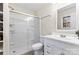 Bathroom featuring a shower with glass doors, white vanity, and shelving unit at 10007 Mountain Apple Dr, Mint Hill, NC 28227