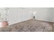 Neutral carpeted bedroom featuring a closet and a decorative shelving unit at 10007 Mountain Apple Dr, Mint Hill, NC 28227