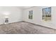 Well-lit bedroom with neutral carpet, two windows, and a display case at 10007 Mountain Apple Dr, Mint Hill, NC 28227
