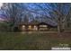 Charming brick home featuring mature landscaping and a well-manicured lawn at 10007 Mountain Apple Dr, Mint Hill, NC 28227