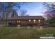 Brick home featuring a well-manicured lawn and mature landscaping at 10007 Mountain Apple Dr, Mint Hill, NC 28227