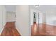 Bright hallway with wood floors and white walls providing a transition to the adjacent rooms at 10007 Mountain Apple Dr, Mint Hill, NC 28227