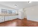 Bright kitchen featuring white cabinets, granite countertops, modern appliances, and a large window at 10007 Mountain Apple Dr, Mint Hill, NC 28227