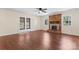 Living room with wood floors, a ceiling fan, French doors, and a brick fireplace at 10007 Mountain Apple Dr, Mint Hill, NC 28227