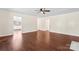 Large living room with a fireplace, wood floors, and neutral walls perfect for relaxing or entertaining at 10007 Mountain Apple Dr, Mint Hill, NC 28227