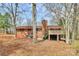 View of the back of this home with a deck and mature trees at 1069 W Rebound Rd, Van Wyck, SC 29720