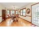 Well-lit dining room with hardwood floors, wood trim windows, and stylish chandelier at 1069 W Rebound Rd, Van Wyck, SC 29720