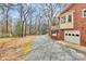 Gravel driveway leads to a brick home, blending with the surrounding trees at 1069 W Rebound Rd, Van Wyck, SC 29720