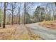 Gravel driveway leads to a wooded area, showing privacy and natural surroundings at 1069 W Rebound Rd, Van Wyck, SC 29720