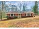 Charming brick home featuring black shutters, a green front door, and a well-maintained front yard at 1069 W Rebound Rd, Van Wyck, SC 29720