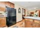 Spacious kitchen with wood cabinets, black appliances, and an open view into another room at 1069 W Rebound Rd, Van Wyck, SC 29720
