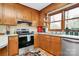 Bright kitchen with wood cabinets, stainless steel appliances, and a window over the sink at 1069 W Rebound Rd, Van Wyck, SC 29720