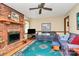 Comfortable living room with a brick fireplace and ceiling fan at 1069 W Rebound Rd, Van Wyck, SC 29720