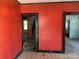 Cozy living room with red accent wall, showcasing black trim and doorways, ready for renovation and personal touches at 107 Lineberger St # 6, Shelby, NC 28150