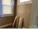 Empty room with bright window and stacked lumber against the wall, ready for customization and transformation at 107 Lineberger St # 6, Shelby, NC 28150