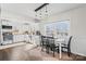 Bright dining area featuring natural light, a modern light fixture, and direct access to a well-equipped kitchen at 108 S Buckoak St, Stanley, NC 28164