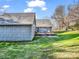 Landscaped backyard with a wooden deck, patio furniture, and mature trees at 111 Oakwood Dr, Kings Mountain, NC 28086