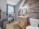 Bathroom with a unique tiled wall, modern vanity, toilet, and neutral color scheme, creating a cozy atmosphere at 111 Oakwood Dr, Kings Mountain, NC 28086