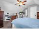 Bright bedroom with a ceiling fan, TV, and ample storage with shelves and dressers at 111 Oakwood Dr, Kings Mountain, NC 28086