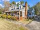 Attractive home featuring a brick chimney, porch with seating, and landscaped yard at 111 Oakwood Dr, Kings Mountain, NC 28086