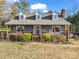 Charming Cape Cod style home with a covered front porch, gray siding, and dormer windows under a blue sky at 111 Oakwood Dr, Kings Mountain, NC 28086