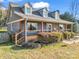 Charming home featuring a cozy front porch, wood accents, and a neatly landscaped yard on a sunny day at 111 Oakwood Dr, Kings Mountain, NC 28086