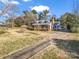 Quaint home with a long driveway and a charming front porch surrounded by trees at 111 Oakwood Dr, Kings Mountain, NC 28086