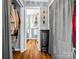 Hallway with view to bathroom and closet, featuring hardwood flooring and decor, perfect for creating functionality at 111 Oakwood Dr, Kings Mountain, NC 28086
