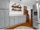 Bright kitchen featuring gray cabinets, stainless steel refrigerator, and hardwood floors at 111 Oakwood Dr, Kings Mountain, NC 28086