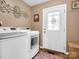 Laundry room features washer, dryer, and access door at 111 Oakwood Dr, Kings Mountain, NC 28086