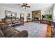 Spacious living room featuring a stone fireplace, plush sofas, and hardwood floors, creating a warm and inviting atmosphere at 111 Oakwood Dr, Kings Mountain, NC 28086
