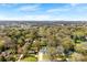 Aerial view of neighborhood showcasing home's location with lush trees and city view at 1121 S Edgemont Ave, Gastonia, NC 28054
