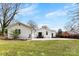 The backyard has a white house with manicured lawn at 1121 S Edgemont Ave, Gastonia, NC 28054