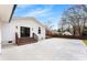 Spacious backyard patio with a white house featuring a staircase and well manicured yard at 1121 S Edgemont Ave, Gastonia, NC 28054