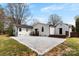 Spacious backyard featuring a modern concrete patio, dark wood decks, and white trim on a home's exterior at 1121 S Edgemont Ave, Gastonia, NC 28054