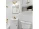 Bathroom with tiled walls, a vanity sink, and a vintage mirror with gold trim at 1121 S Edgemont Ave, Gastonia, NC 28054