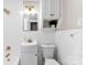 Cozy bathroom featuring tiled walls, a vanity sink, and a vintage mirror at 1121 S Edgemont Ave, Gastonia, NC 28054