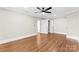 Large bedroom with hardwood floors, a ceiling fan, and ensuite bathroom at 1121 S Edgemont Ave, Gastonia, NC 28054