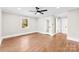 Bright bedroom with refinished hardwood floors, fresh paint, modern ceiling fan, new windows, and ensuite bathroom at 1121 S Edgemont Ave, Gastonia, NC 28054