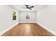 Bedroom with hardwood floors, a ceiling fan, and two bright windows at 1121 S Edgemont Ave, Gastonia, NC 28054