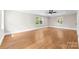 Bright bedroom with refinished hardwood floors, fresh paint, modern ceiling fan, and natural light from new windows at 1121 S Edgemont Ave, Gastonia, NC 28054