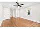 Spacious bedroom with hardwood flooring, ceiling fan, and modern trim details at 1121 S Edgemont Ave, Gastonia, NC 28054