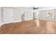 Bright bedroom with refinished hardwood floors, fresh paint, modern ceiling fan, and access to ensuite bathroom at 1121 S Edgemont Ave, Gastonia, NC 28054