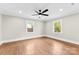 Bright bedroom with refinished hardwood floors, fresh paint, modern ceiling fan, and natural light from new windows at 1121 S Edgemont Ave, Gastonia, NC 28054