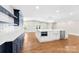 Open-concept kitchen with a large island, stainless appliances, and a stylish chandelier at 1121 S Edgemont Ave, Gastonia, NC 28054