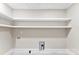 Bright laundry room featuring tiled floors, fresh paint, and utility hook ups at 1121 S Edgemont Ave, Gastonia, NC 28054