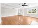 Living room with hardwood floors, a ceiling fan, and a bright window at 1121 S Edgemont Ave, Gastonia, NC 28054