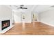 Bright living room with hardwood floors and a fireplace at 1121 S Edgemont Ave, Gastonia, NC 28054
