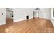 Bright and airy living room with hardwood floors, a fireplace, neutral walls, and lots of natural light at 1121 S Edgemont Ave, Gastonia, NC 28054