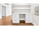 Bright and airy office space with custom built-in desk, floating shelves, neutral walls and hardwood floors at 1121 S Edgemont Ave, Gastonia, NC 28054